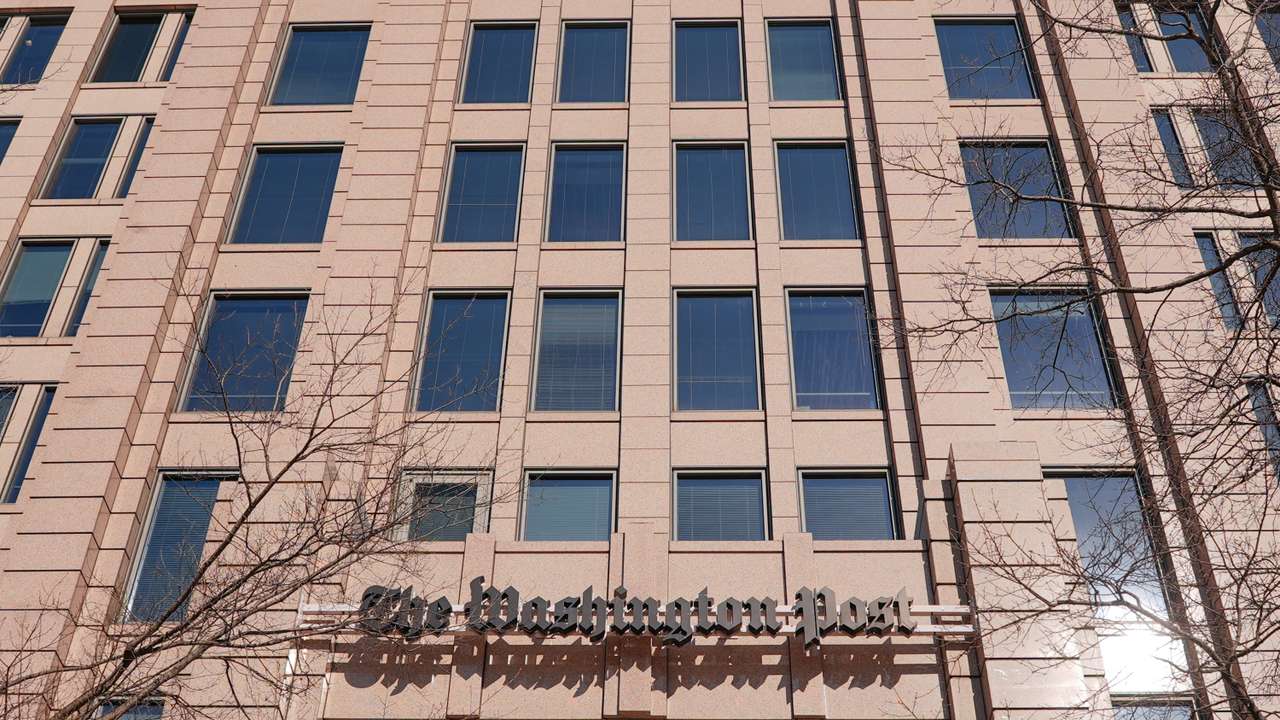 Union members and supporters rally outside The Washington Post after widespread layoffs