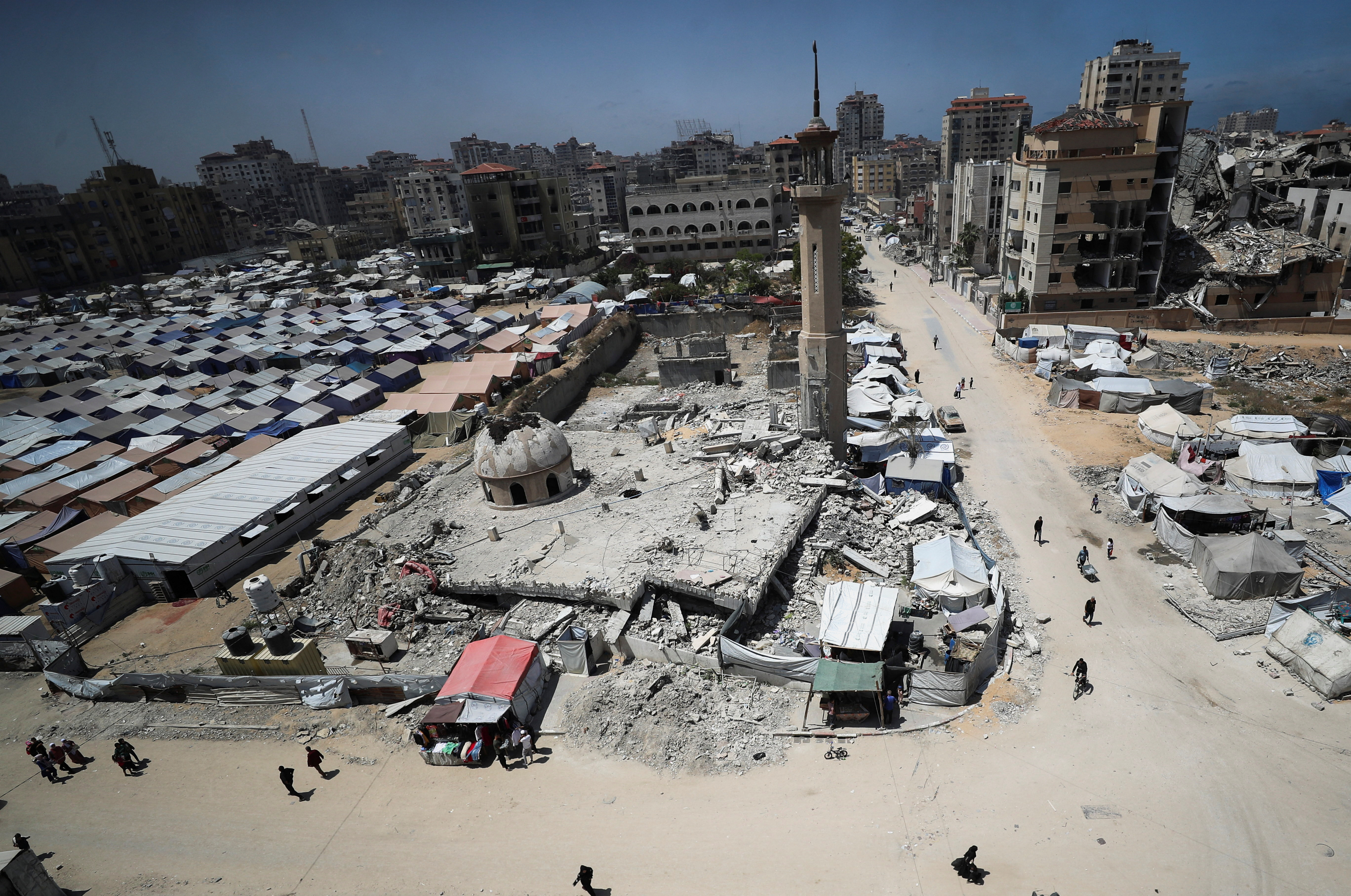 Palestinians displaced by the Israeli military offensive, shelter in tents, in Gaza