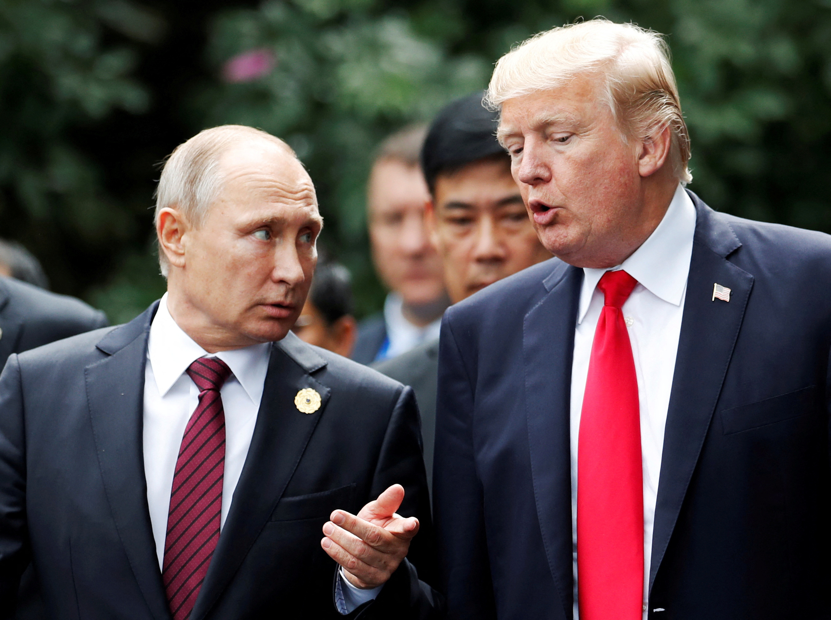 FILE PHOTO: U.S. President Donald Trump and Russia's President Vladimir Putin talk during the family photo session at the APEC Summit in Danang, Vietnam