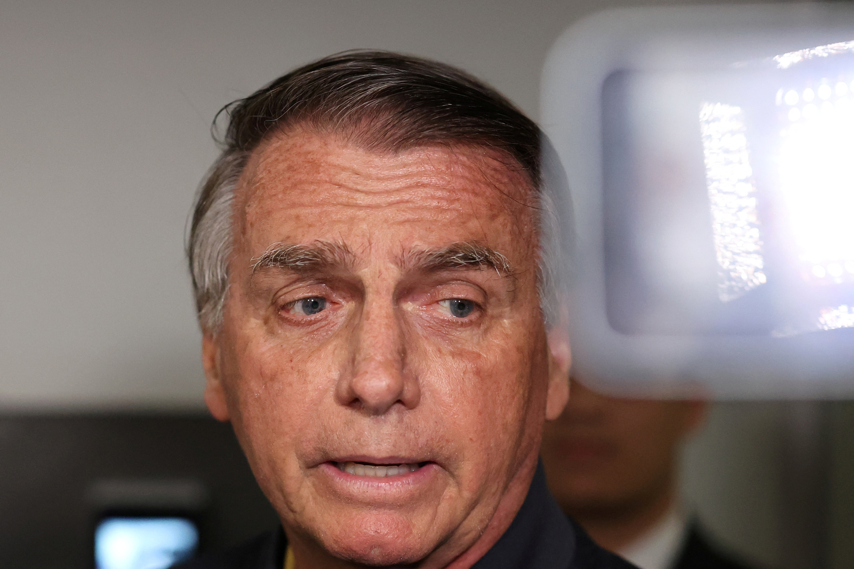 Former Brazilian President Jair Bolsonaro leaves the Liberal Party headquarters in Brasilia