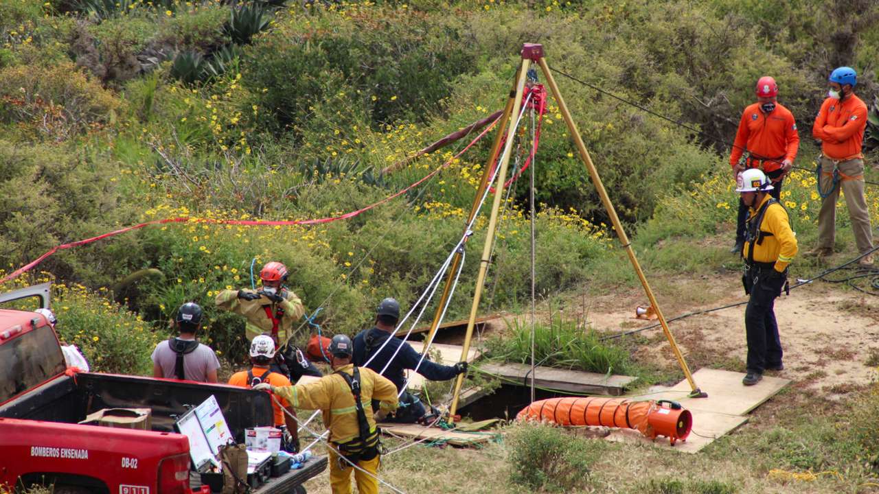 Members of a rescue team work at a site where three bodies were found, in La Bocana