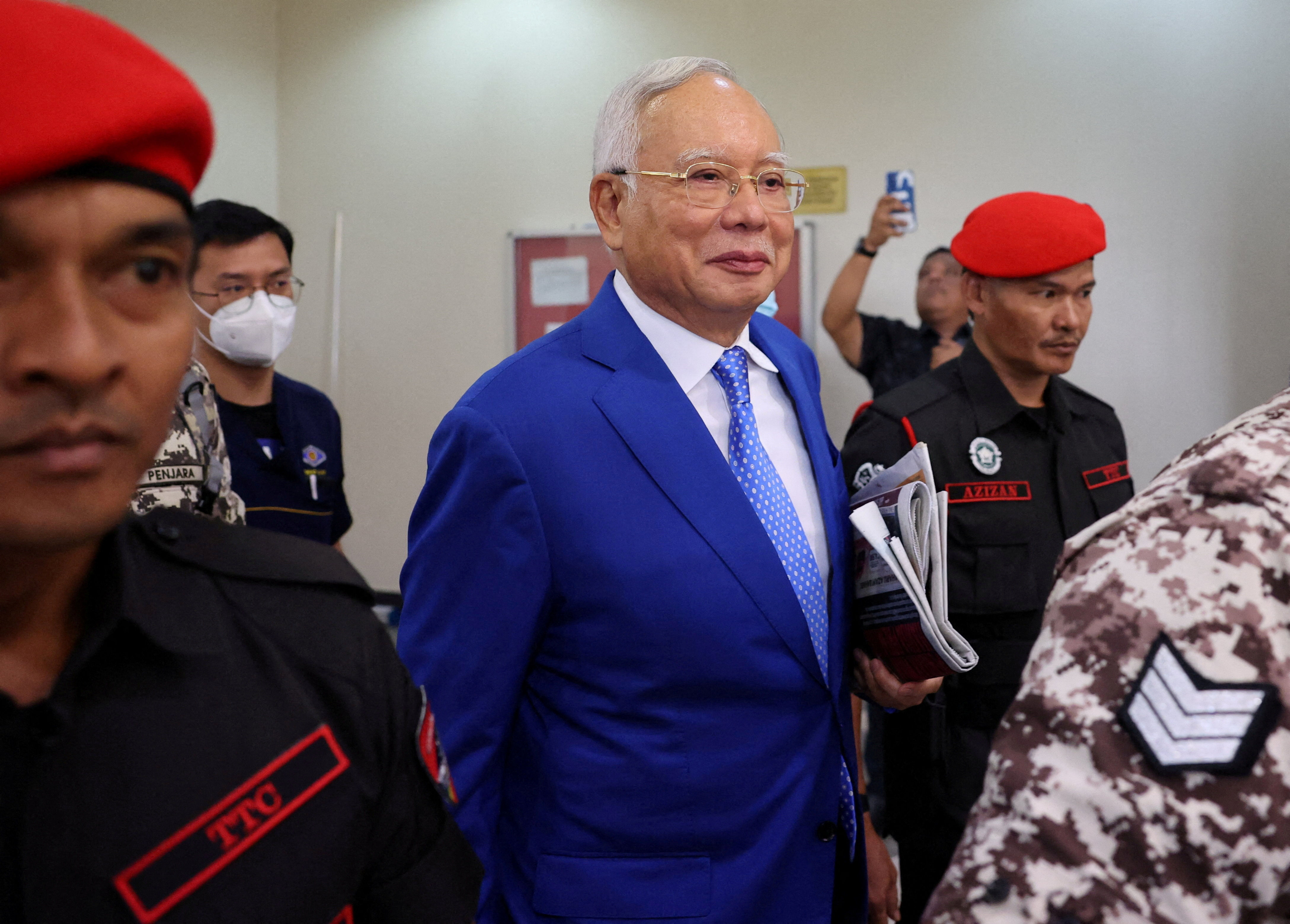 FILE PHOTO: Former Malaysian Prime Minister Najib Razak escorted by prison officers as the jailed politician left the court after court proceedings in Kuala Lumpur