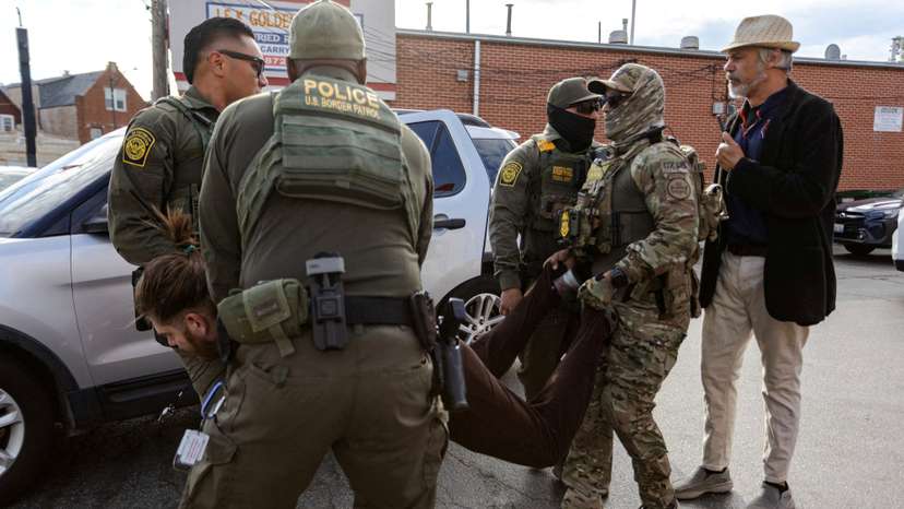 FILE PHOTO: Federal agents in Chicago detain a man after a standoff with community members