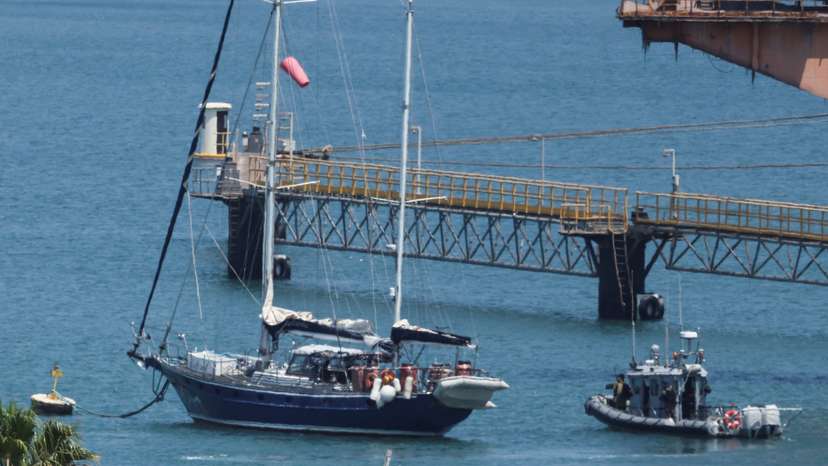Gaza-bound British-flagged yacht "Madleen" is docked next to a military boat Ashdod port following a takeover by the Israeli army, in Ashdod