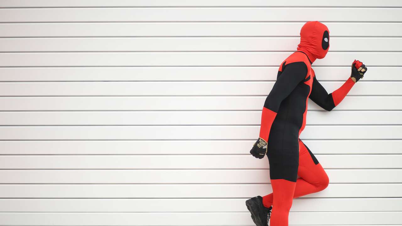 Ricky Santiago dressed as Deadpool from the Marvel comic book poses for a photograph at the London supercomic convention at the Excel centre in east London
