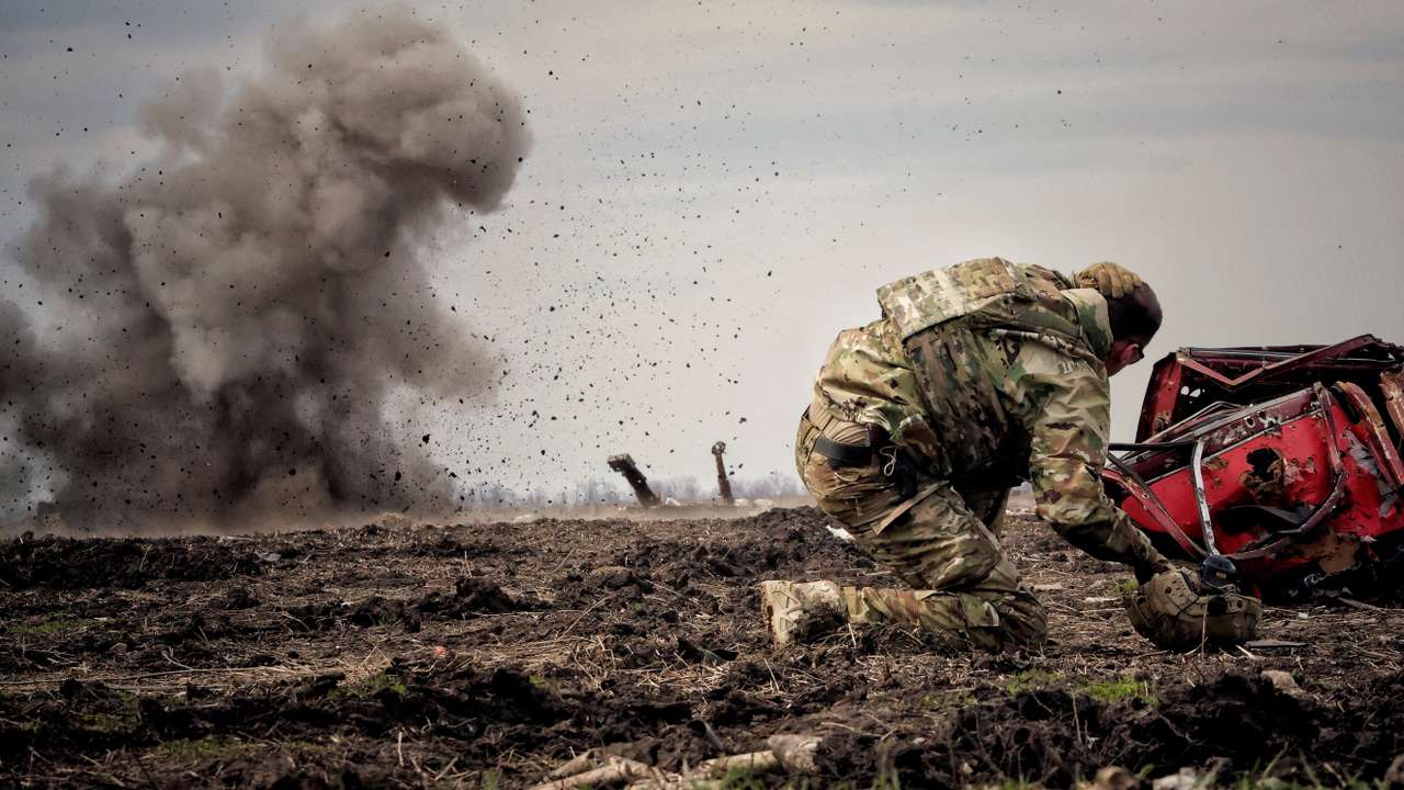 Ukrainian serviceman reacts as he throws a grenade during a training in Donbas region
