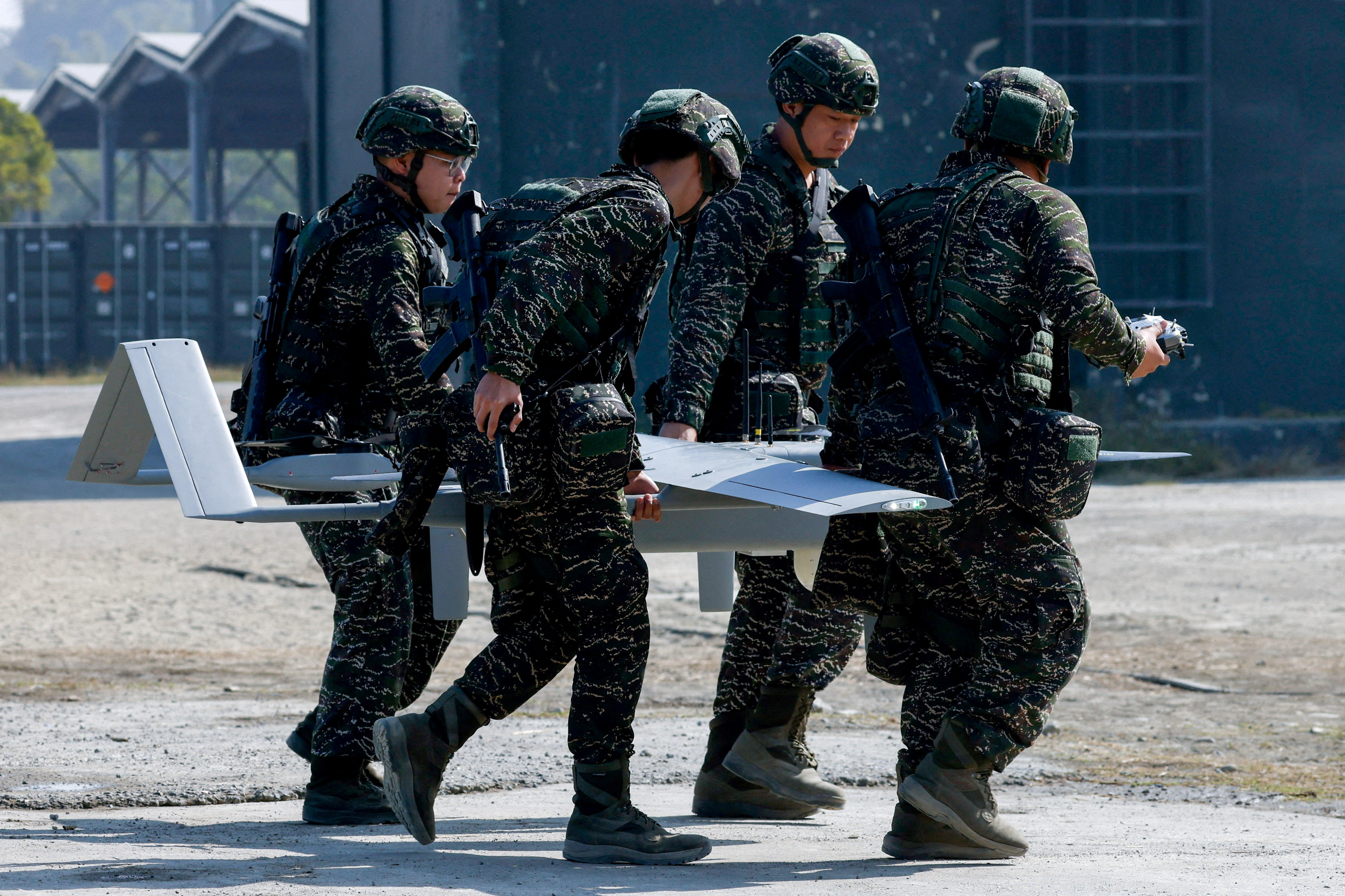 FILE PHOTO: Taiwanese soldiers carry a land-based Surveillance UAV/UAS during an annual military exercise ahead of the Lunar New Year, in Kaohsiung