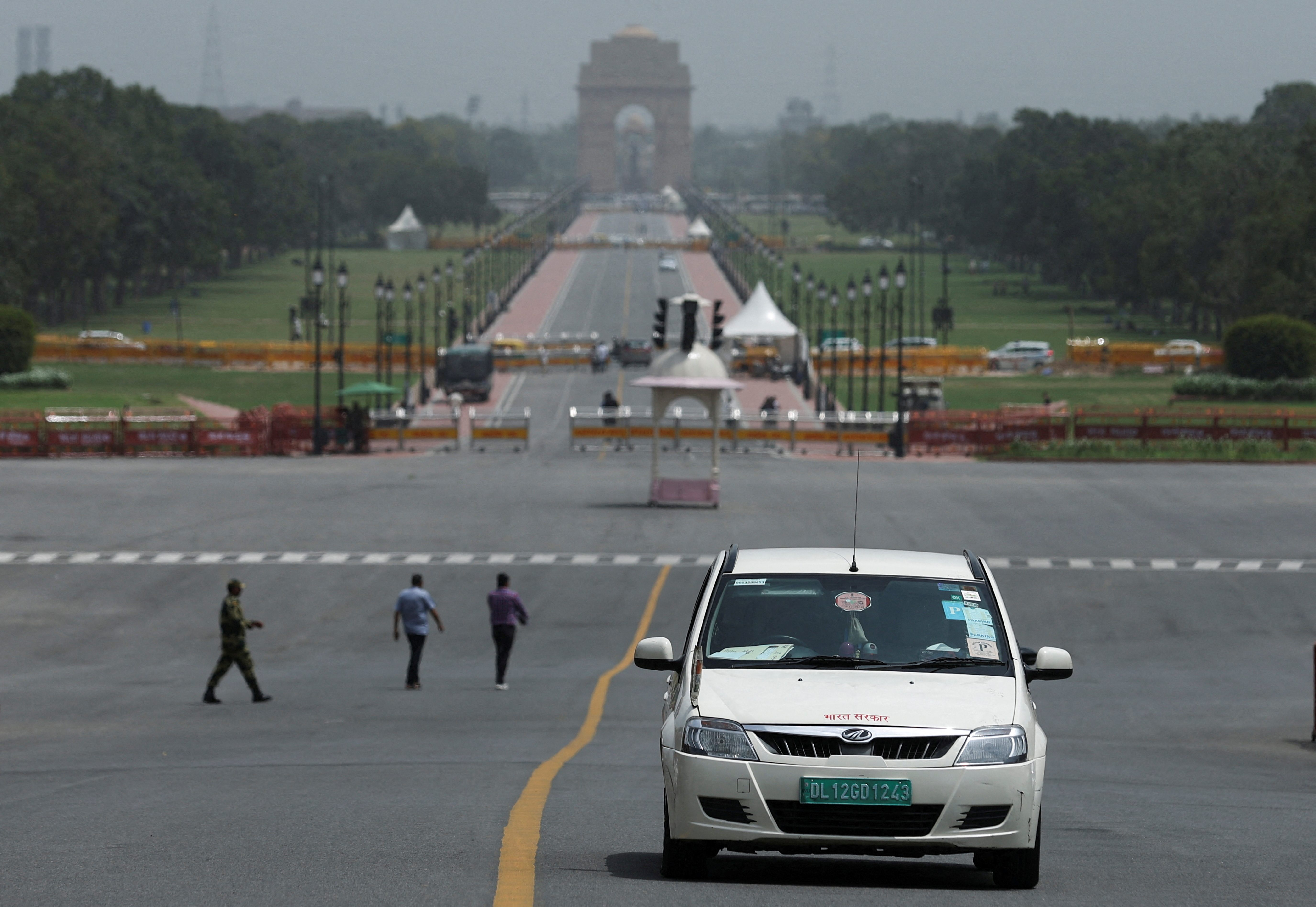 FILE PHOTO: An electric vehicle is driven on the road near India Gate in New Delhi