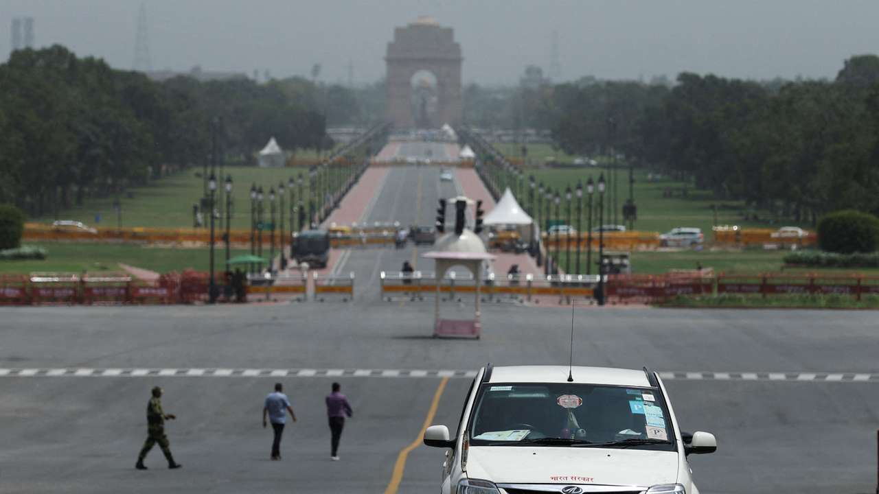 FILE PHOTO: An electric vehicle is driven on the road near India Gate in New Delhi