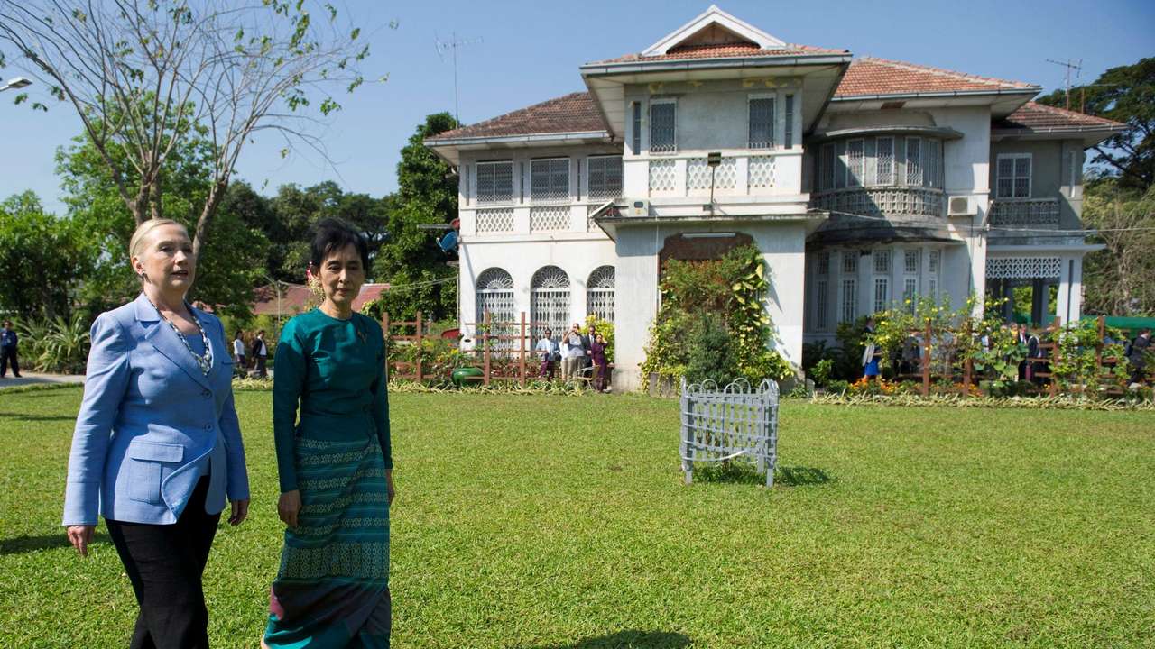 FILE PHOTO: US Secretary of State Clinton and Myanmar's pro-democracy leader Suu Kyi tour the grounds after their meeting at Suu Kyi's house in Yangon
