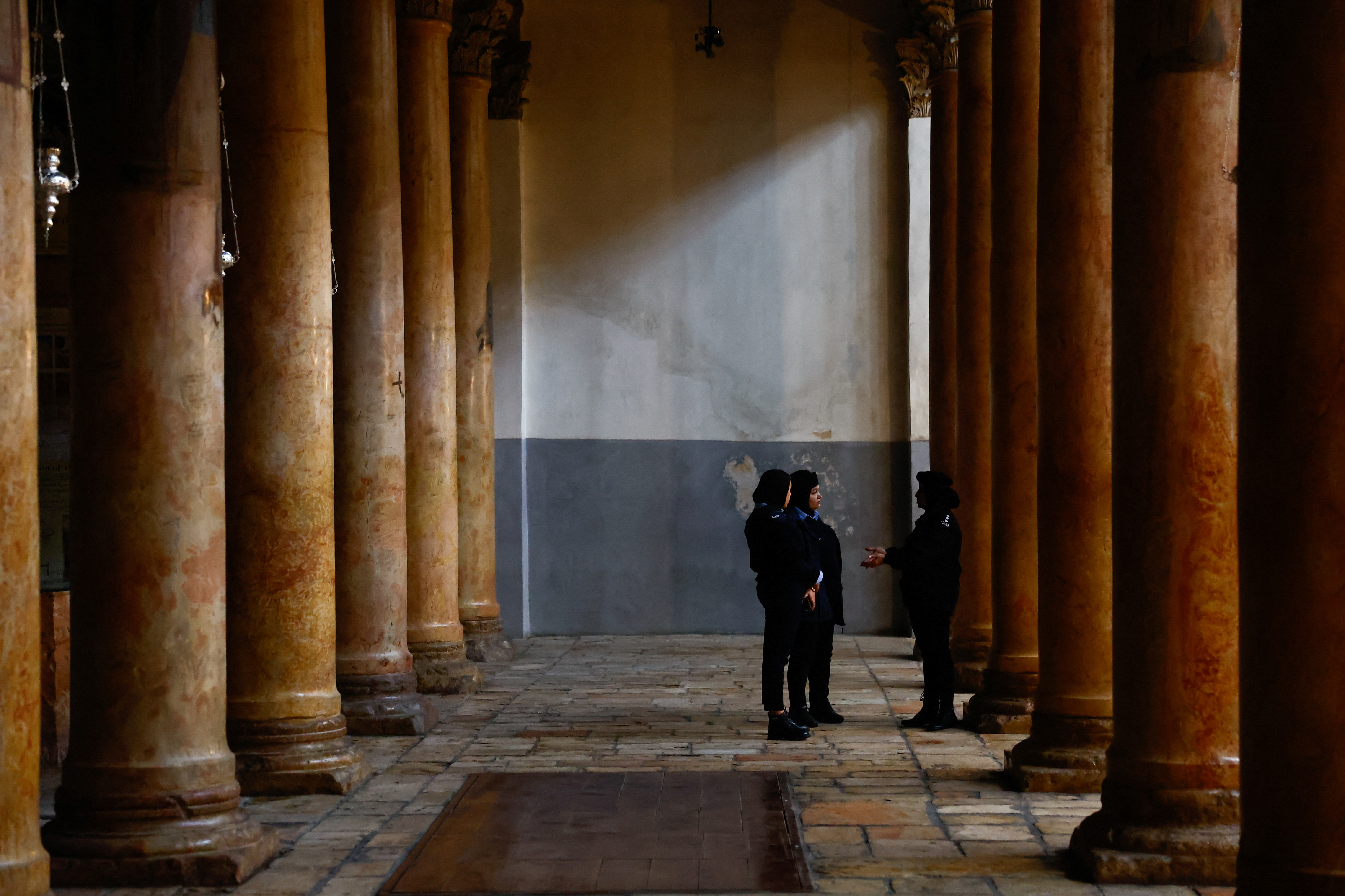 Palestinian police officers stand in the Church of the Nativity in Bethlehem
