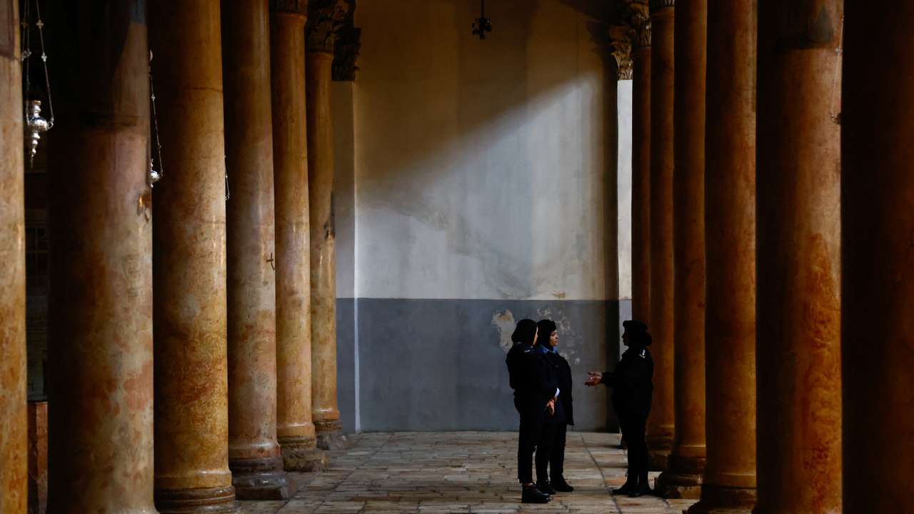 Palestinian police officers stand in the Church of the Nativity in Bethlehem