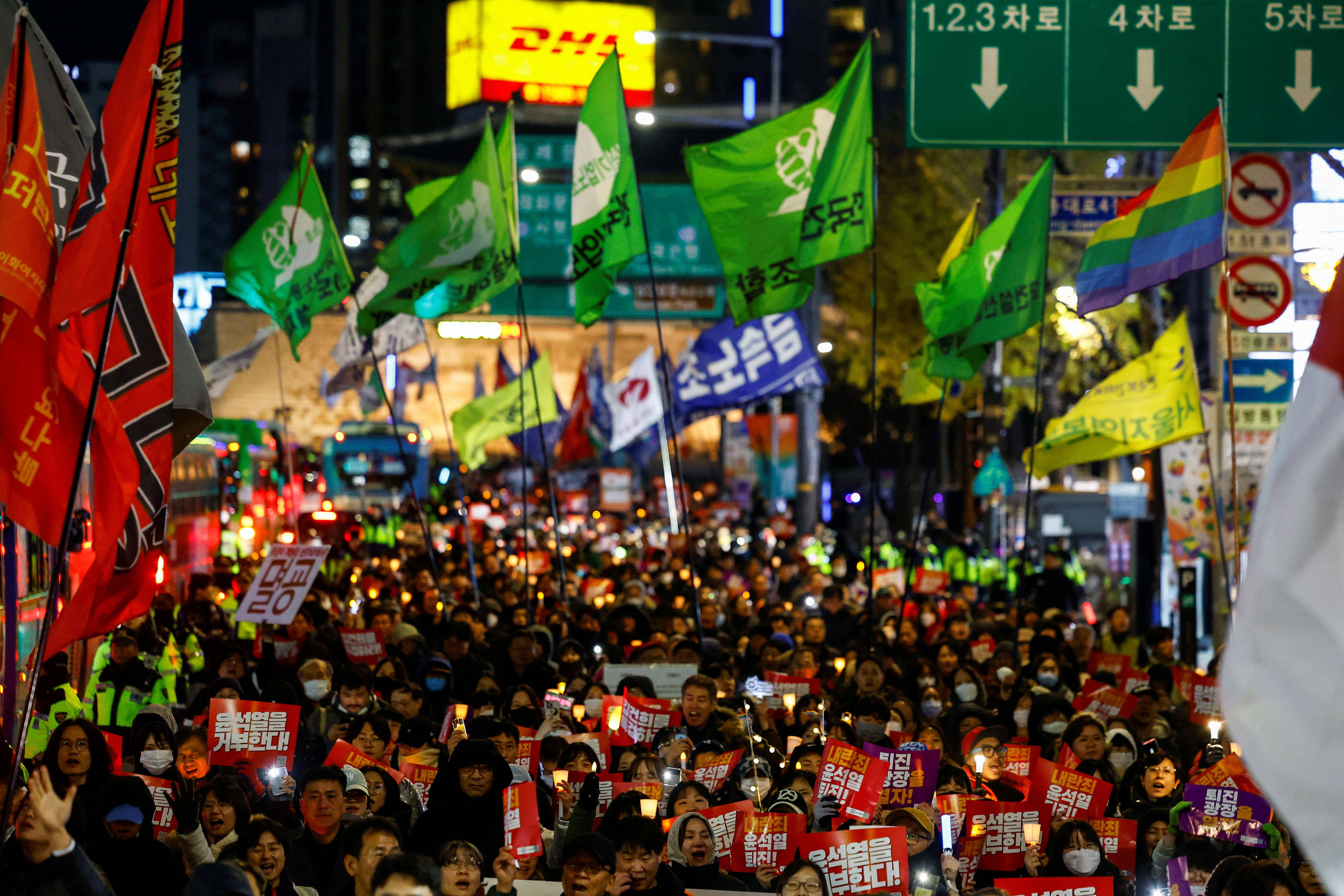 People protest during a candlelight vigil calling for the resignation of South Korean President Yoon Suk Yeol, in Seoul
