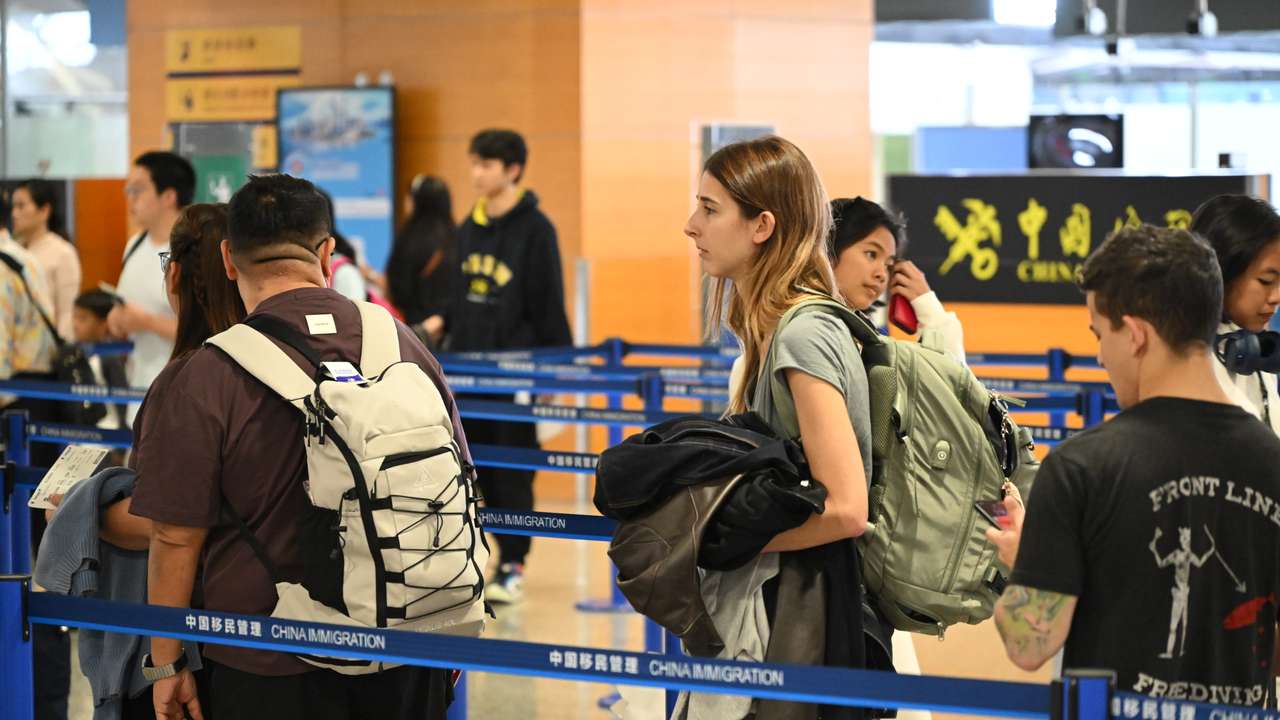 SHANGHAI, CHINA - MAY 30: International travelers walk through an immigration checkpoint at Shanghai Pudong International Airport on May 30, 2025 in Shanghai, China. The expansion of China's visa-free policy has led to a growing number of foreign travelers entering the country through Shanghai ports, prompting local travel agencies to actively develop new tourism products to meet their diverse needs. (Photo by VCG/VCG )No Use China.