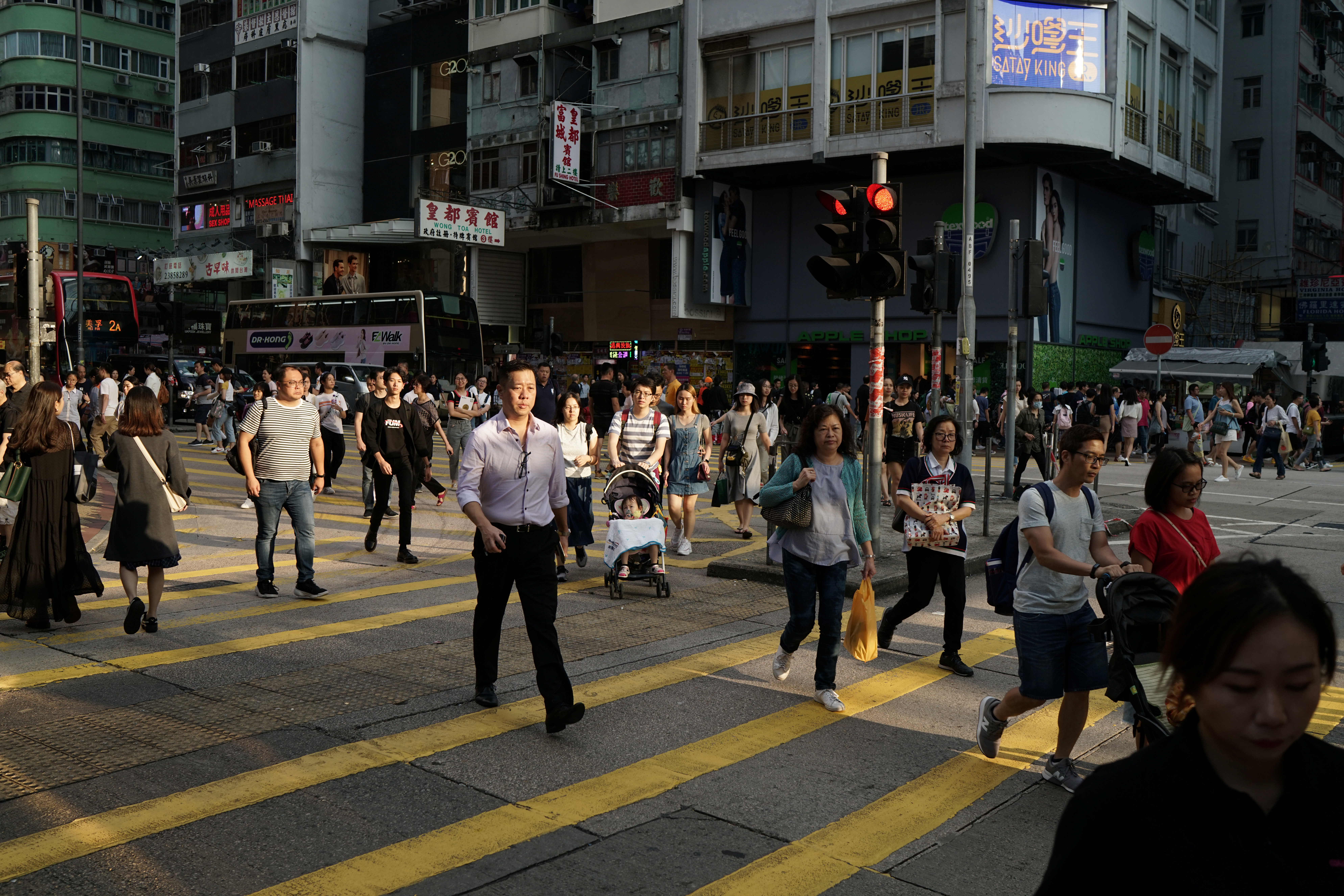 People walk in a street in Hong Kong