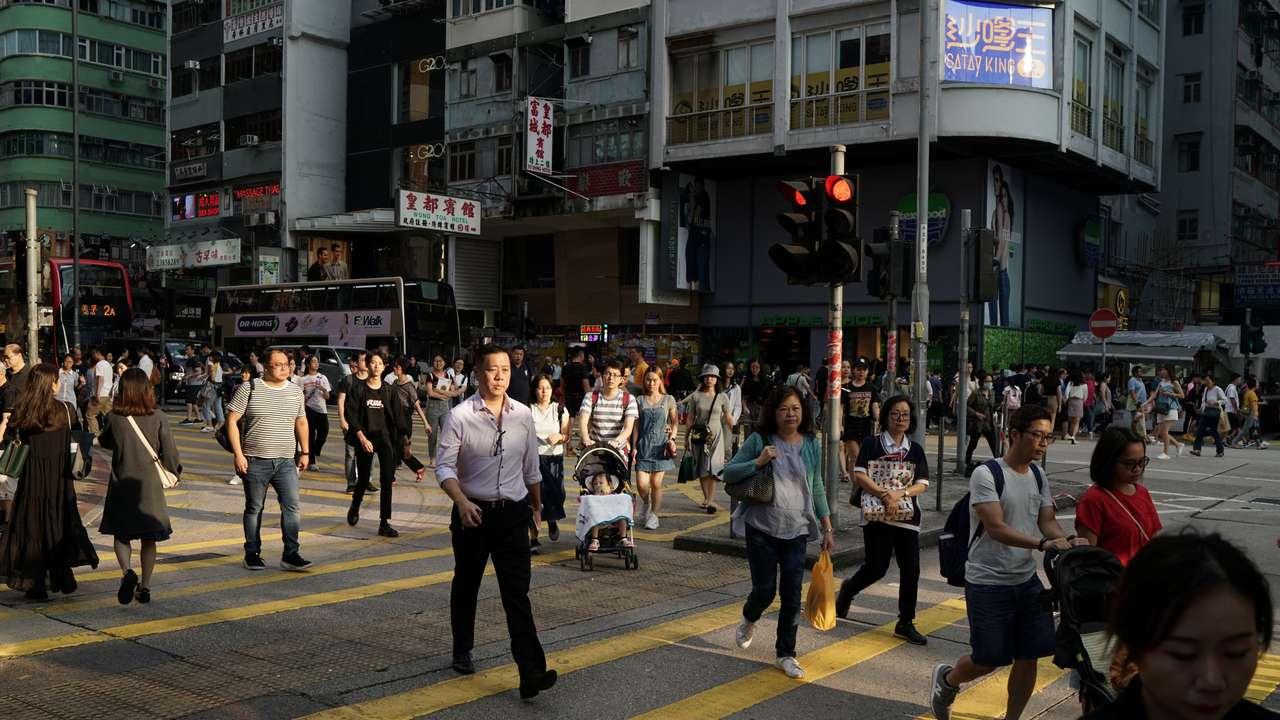 People walk in a street in Hong Kong
