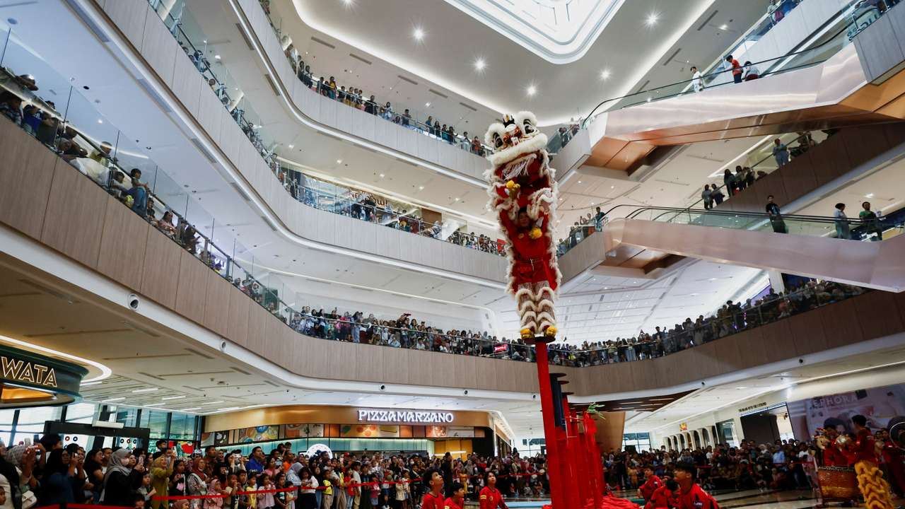 Youths perform Chinese Lion dance at a shopping mall ahead of the Lunar New Year celebrations in South Tangerang