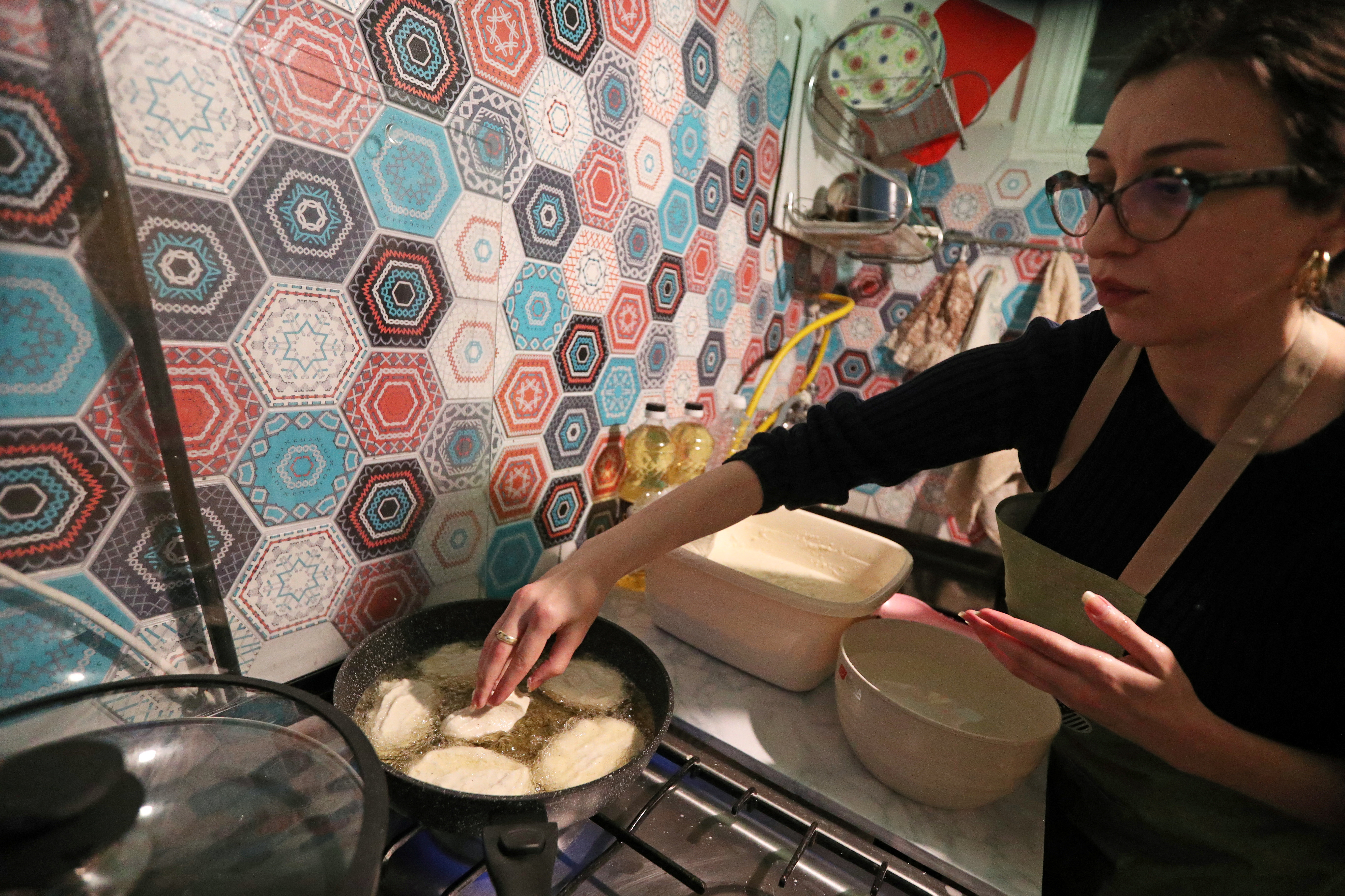 Artist Gogona Parkaia cooks traditional Georgian cornbread for her fellow demonstrators in Tbilisi
