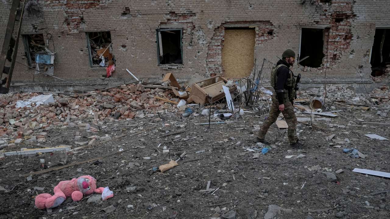 FILE PHOTO: A Ukrainian serviceman walks near destroyed building in the frontline town of Chasiv Yar