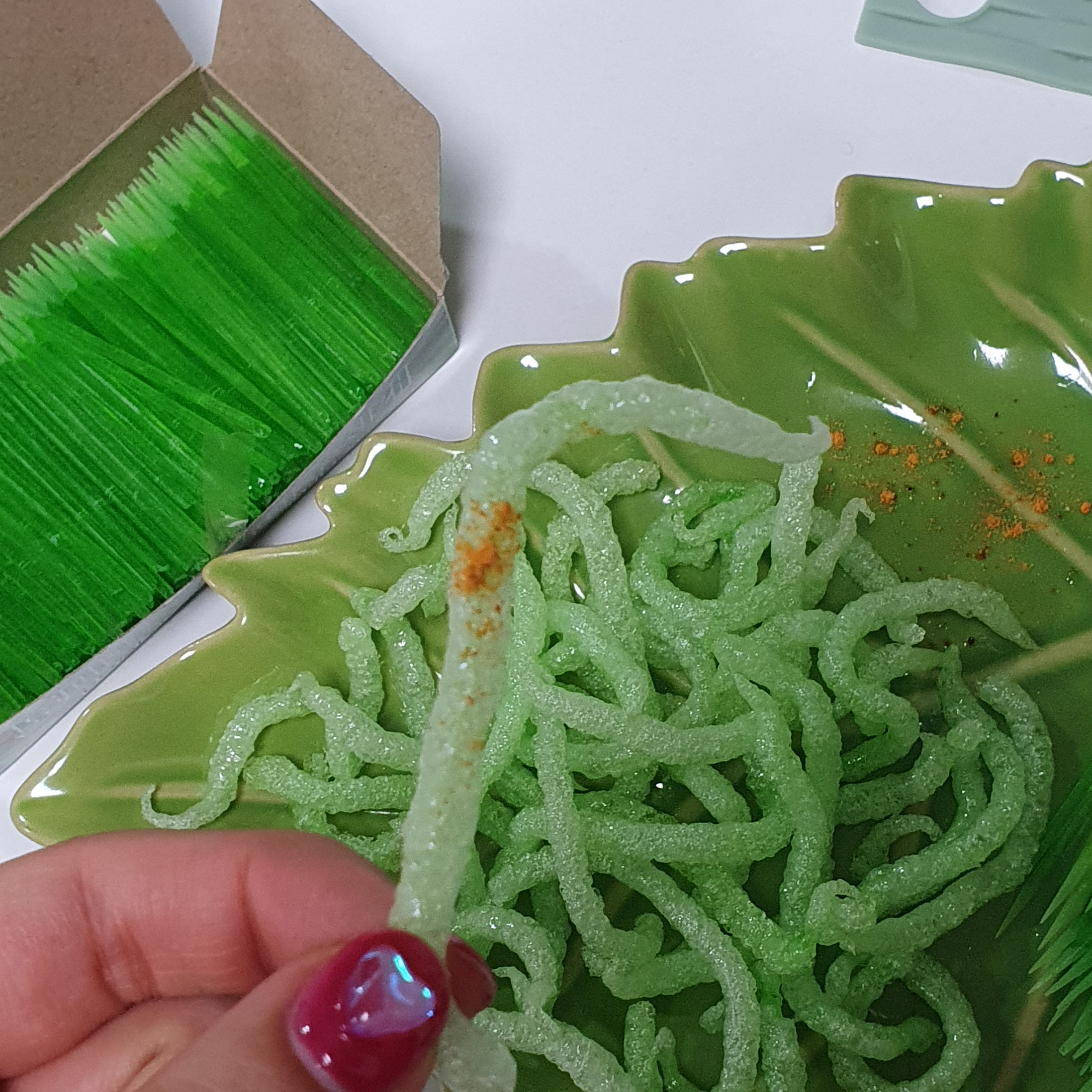 A person holds a "Fried green toothpick" which went viral following a social media trend, against which South Korea's food and drug safety authorities have issued warnings regarding its consumption, in Busan