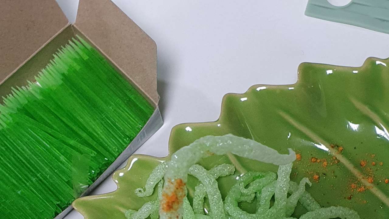 A person holds a "Fried green toothpick" which went viral following a social media trend, against which South Korea's food and drug safety authorities have issued warnings regarding its consumption, in Busan