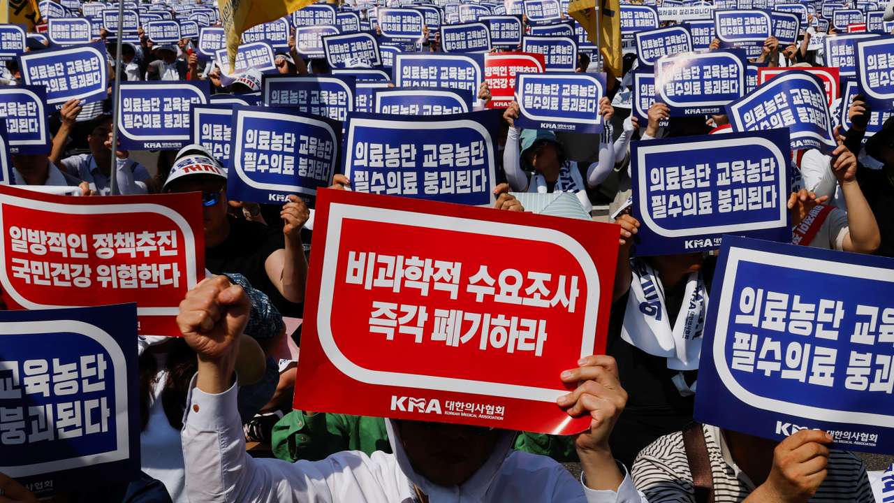 Doctors strike and shout slogans during a rally to protest against government plans to increase medical school admissions and healthcare reform in Seoul