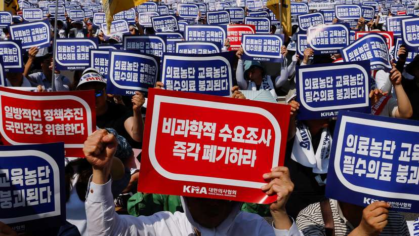 Doctors strike and shout slogans during a rally to protest against government plans to increase medical school admissions and healthcare reform in Seoul