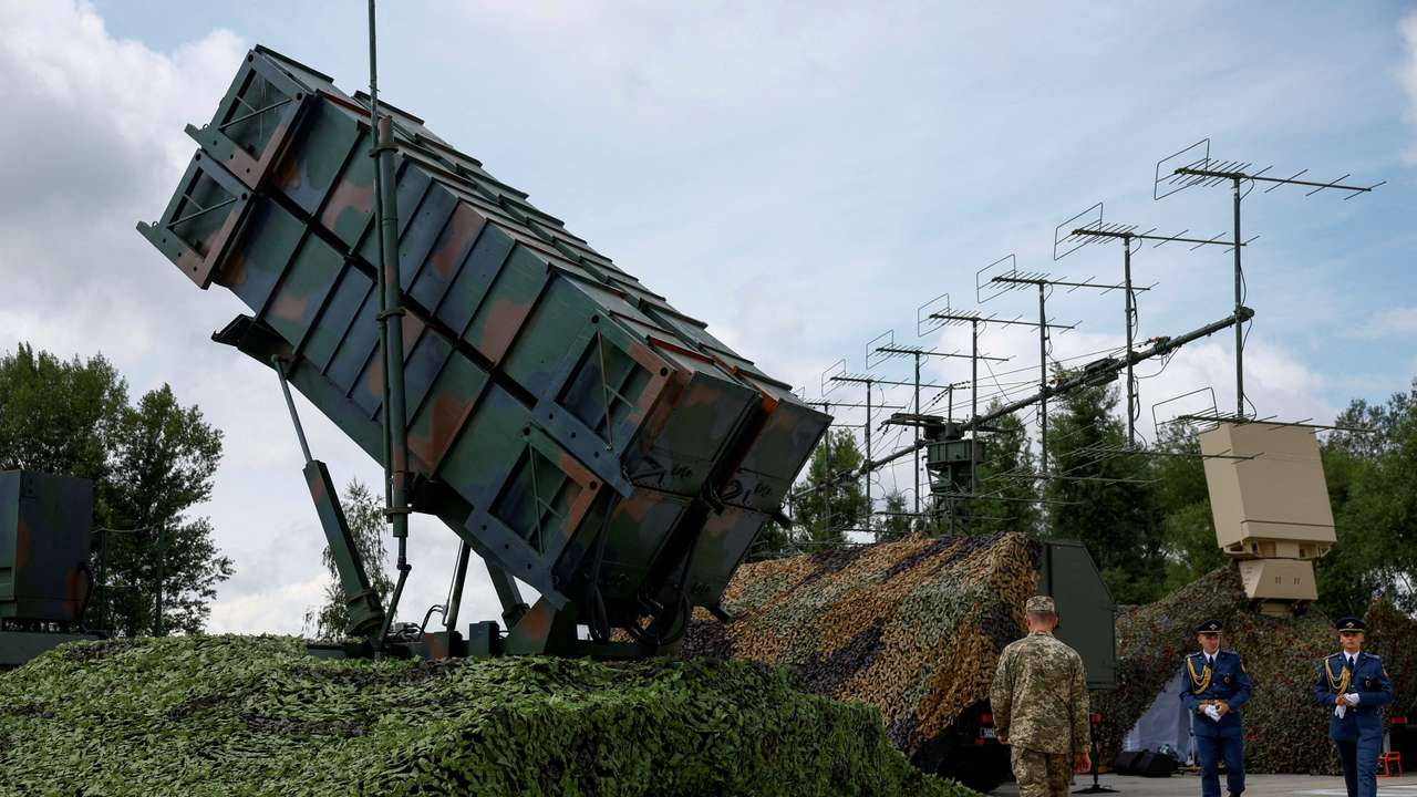 FILE PHOTO: Ukrainian service members walk next to a launcher of a Patriot air defence system an undisclosed location in Ukraine
