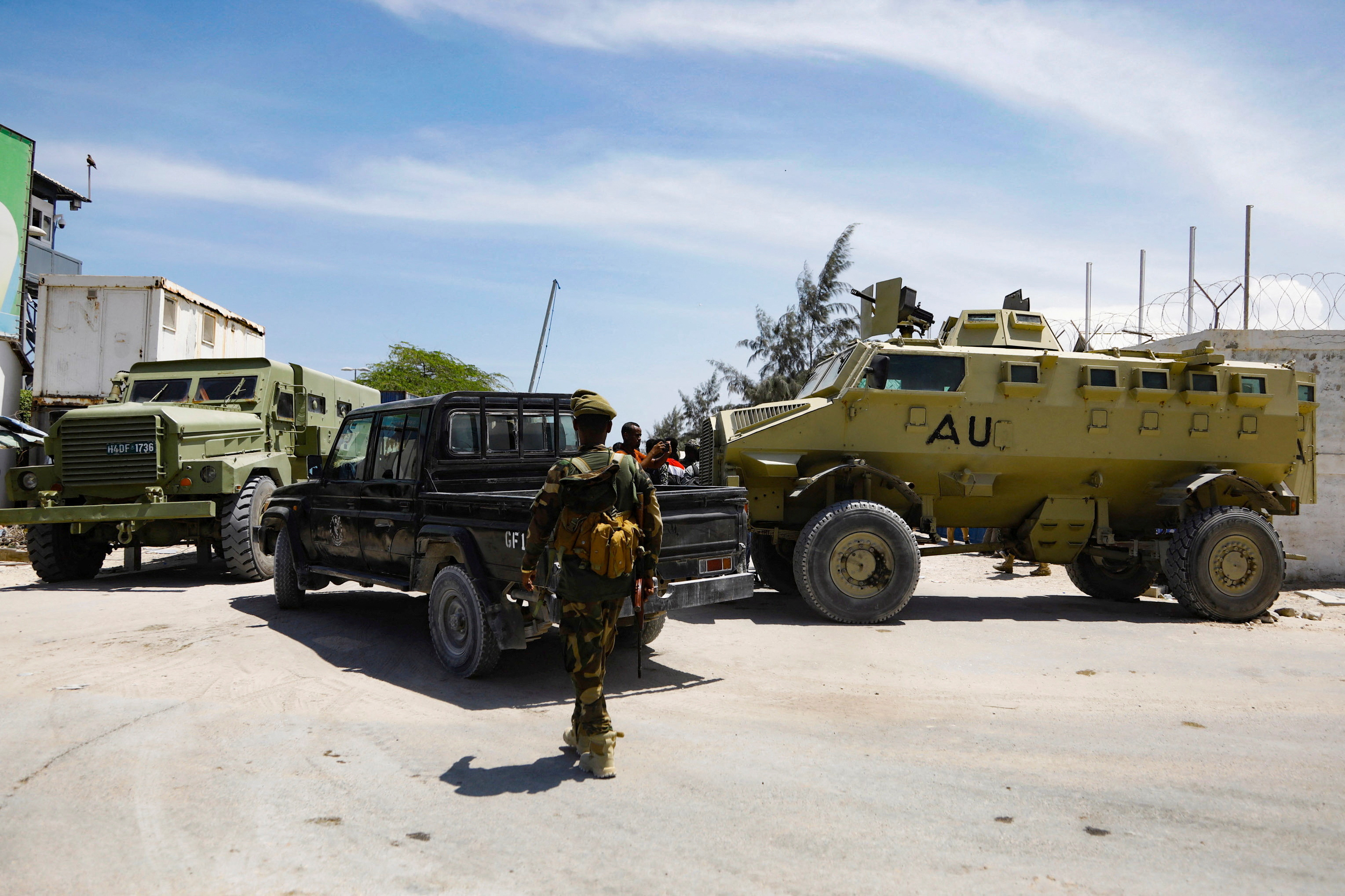 FILE PHOTO: African Union peacekeepers stand next to APC's as they provide security for members of the Lower House of Parliament, in Mogadishu