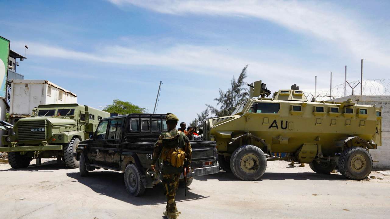 FILE PHOTO: African Union peacekeepers stand next to APC's as they provide security for members of the Lower House of Parliament, in Mogadishu