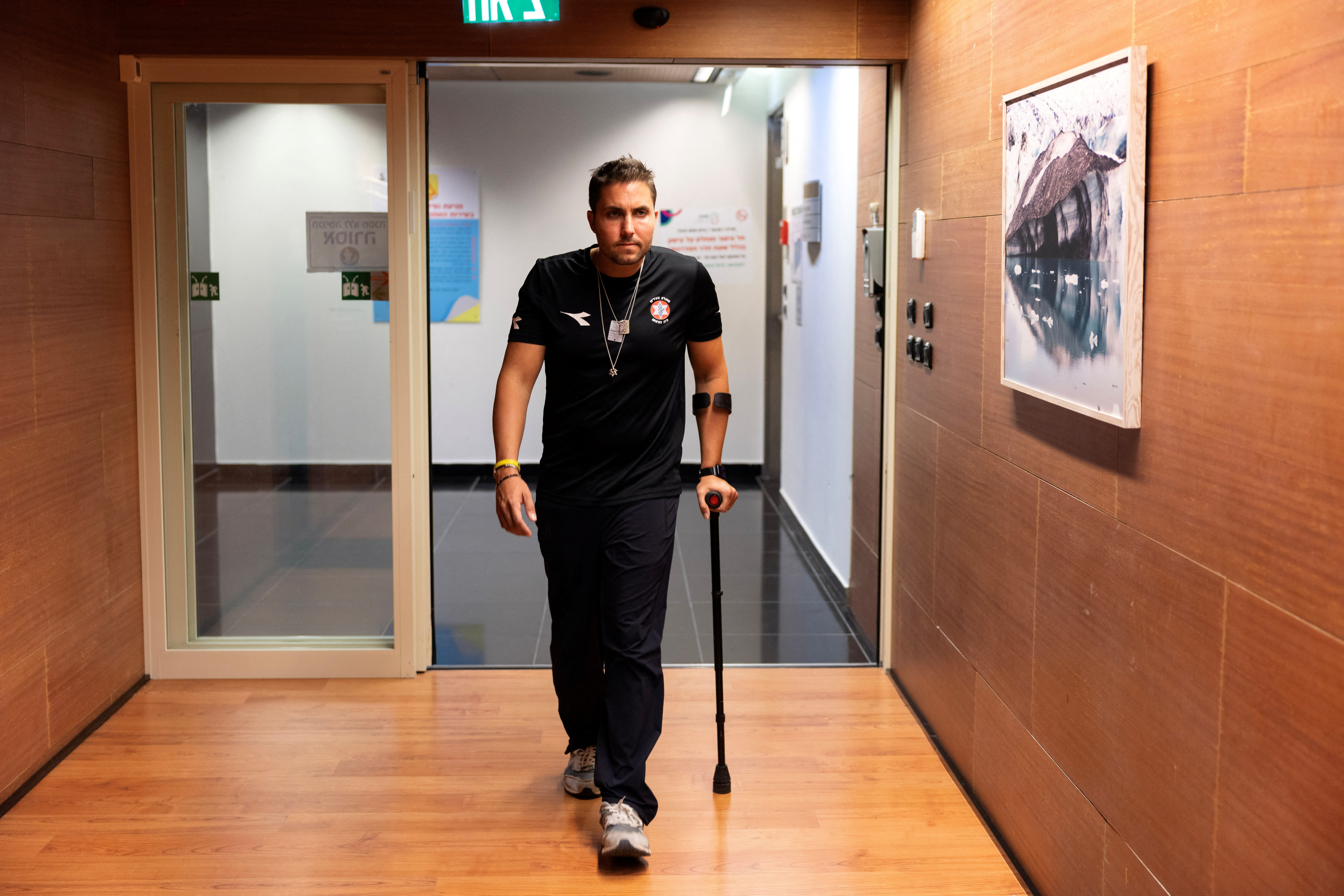 Yosi Sochr, 34, an Israeli reservist and father of four who was severely wounded fighting in Gaza, uses a crutch as he recovers at Sheba Medical Centre in Ramat Gan