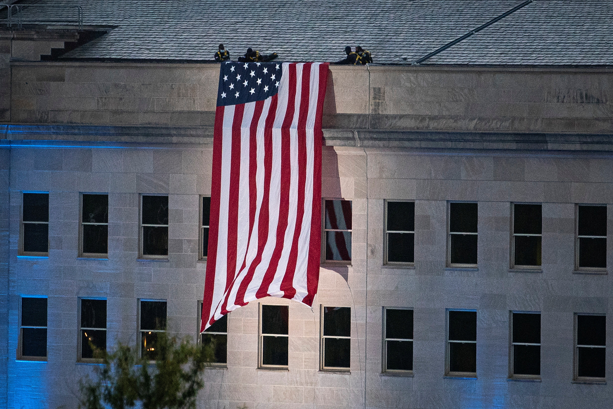 FILE PHOTO: An American flag is unfurled from the roof of the Pentagon