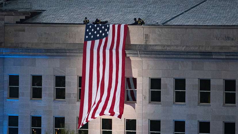 FILE PHOTO: An American flag is unfurled from the roof of the Pentagon