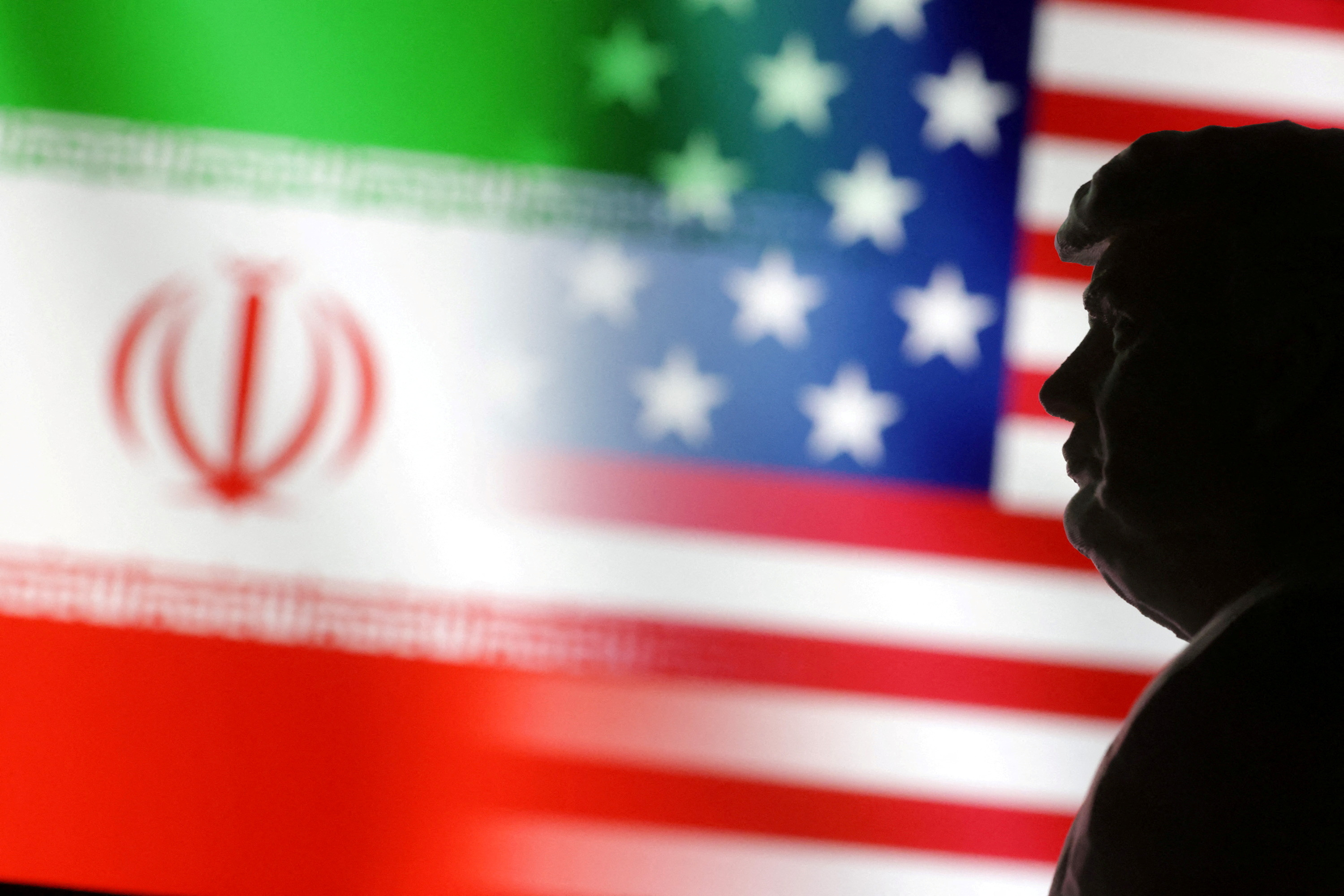 FILE PHOTO: Illustration shows 3D-printed miniature model of U.S. President Donald Trump, and U.S. and Iran flags