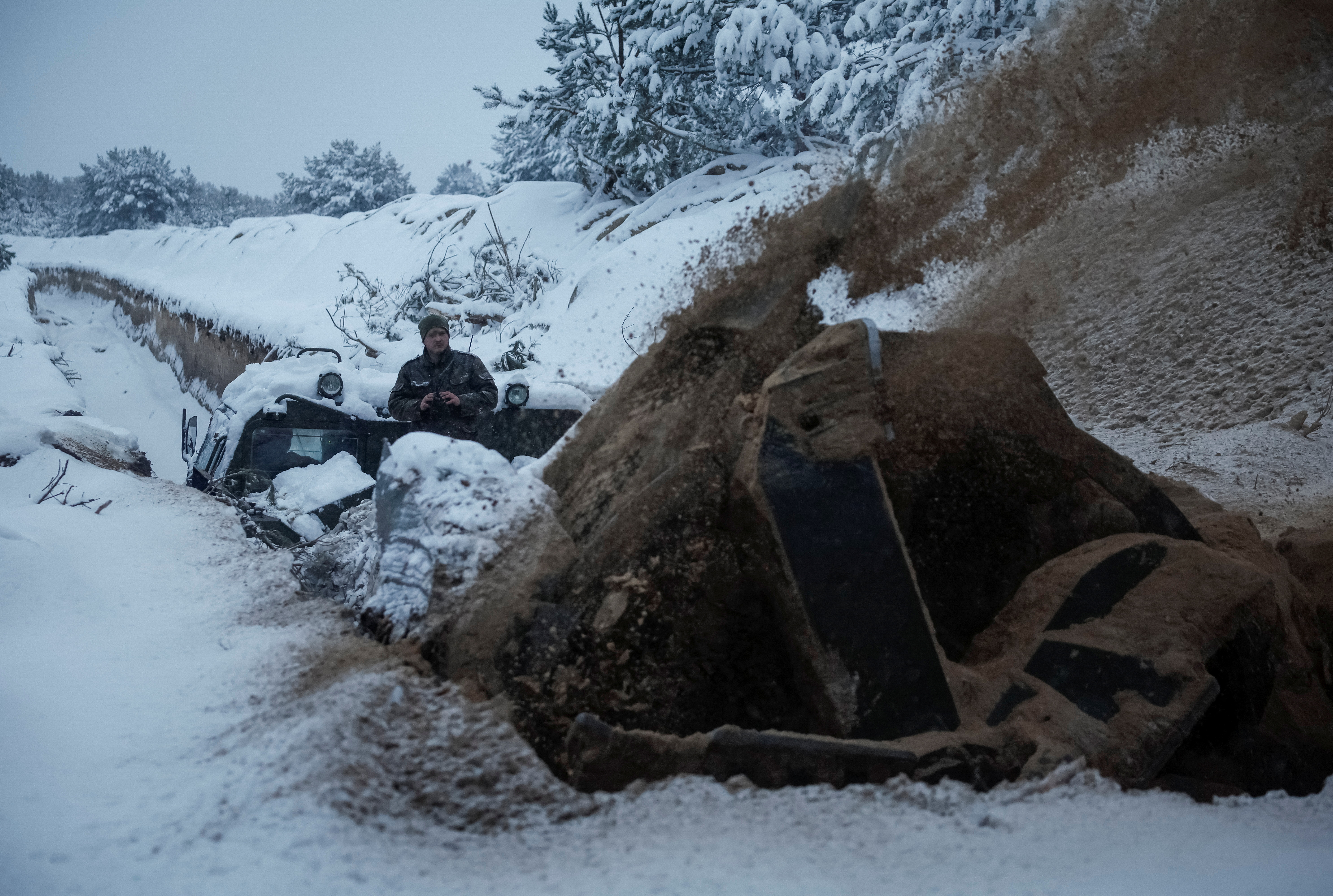 A Ukrainian serviceman digs an anti tank ditch with a MDK-3 military engineering vehicle near Belarus border in Chornobyl exclusion zone