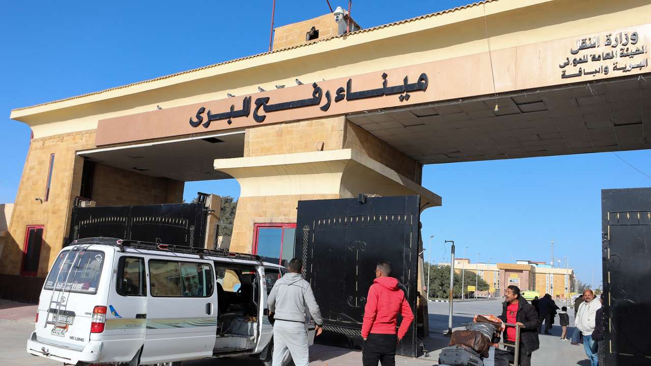 A man pushes a trolley with luggage as he crosses from Gaza to Egypt, at the Rafah border crossing