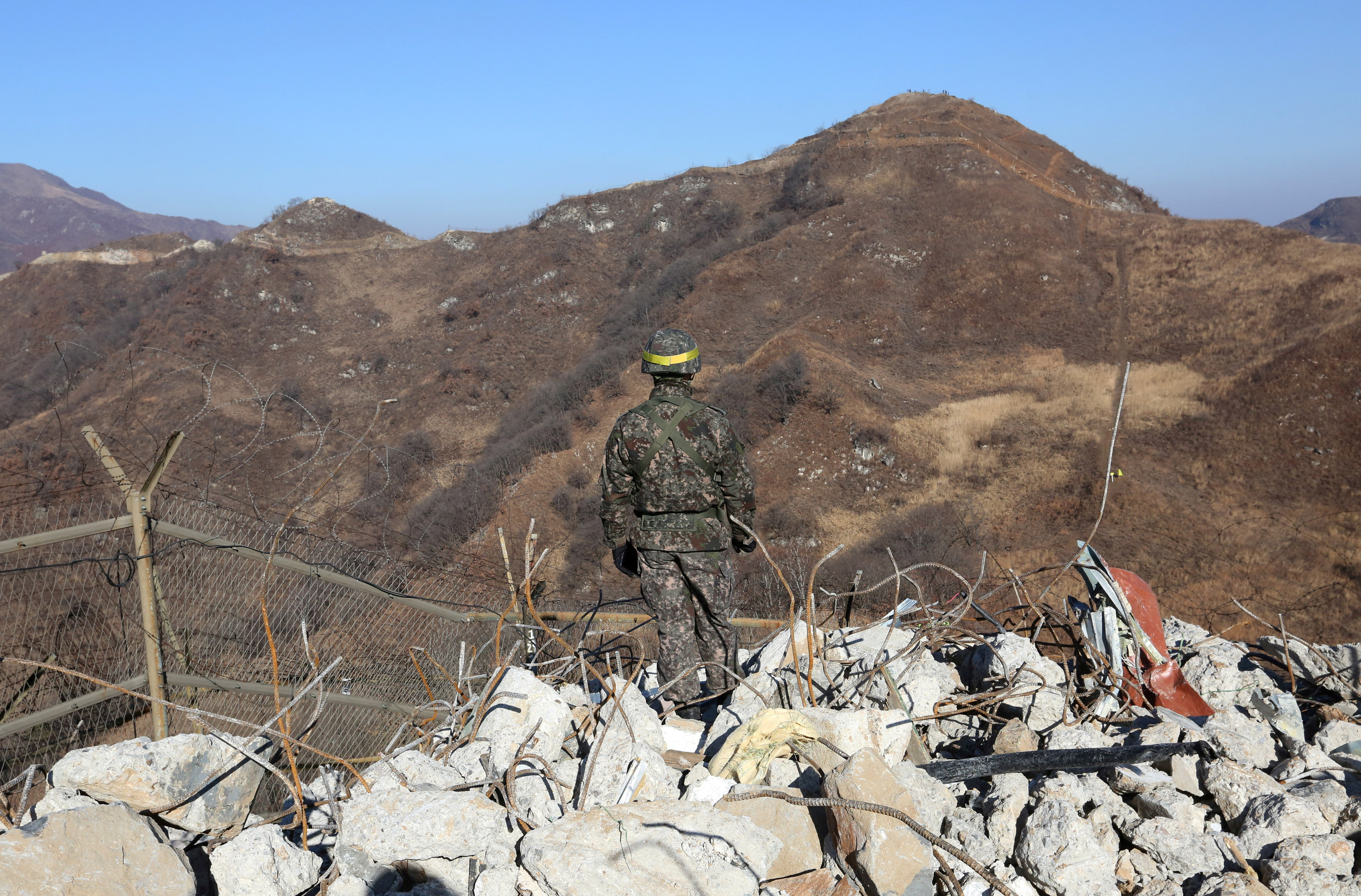 FILE PHOTO: A South Korean army soldier stands guard at the South's dismantled guard post inside the Demilitarized Zone (DMZ) in the central section of the inter-Korean border in Cheorwon