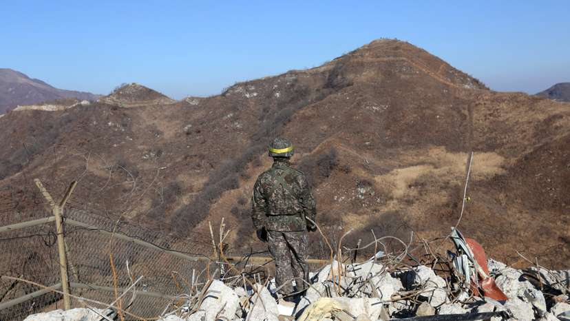 FILE PHOTO: A South Korean army soldier stands guard at the South's dismantled guard post inside the Demilitarized Zone (DMZ) in the central section of the inter-Korean border in Cheorwon
