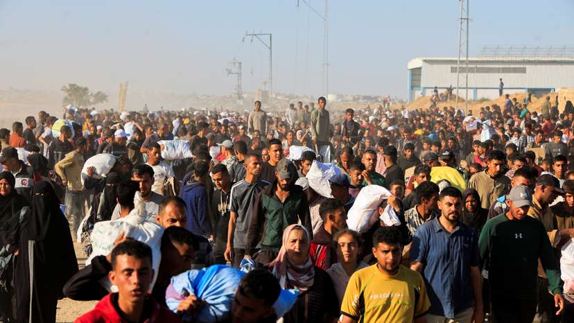 Palestinians receive aid from the U.S.-backed Gaza Humanitarian Foundation, in Khan Younis
