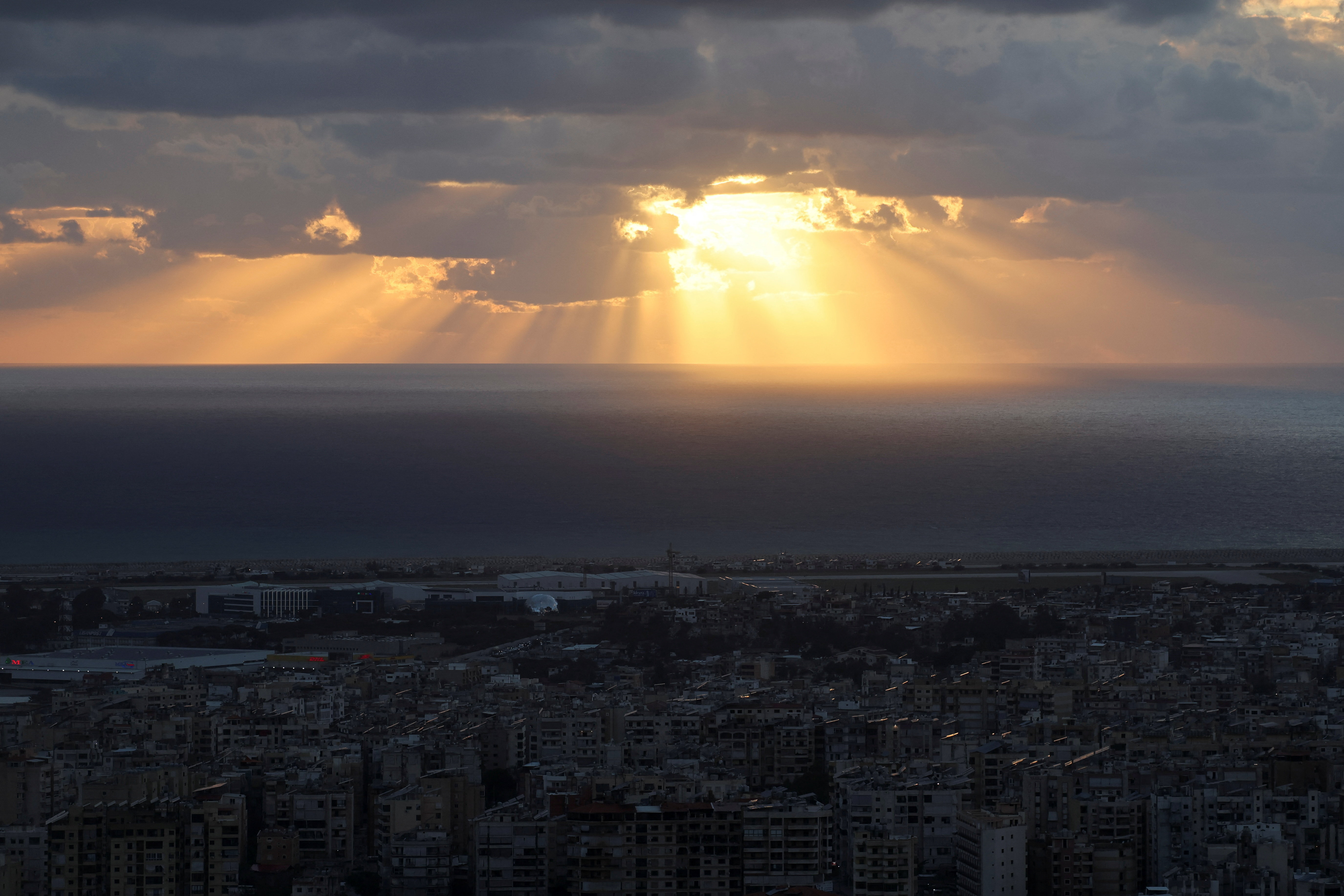 Rays of sunlight break through a cloud over Beirut's southern suburbs, amid escalating hostilities between Israel and Hezbollah