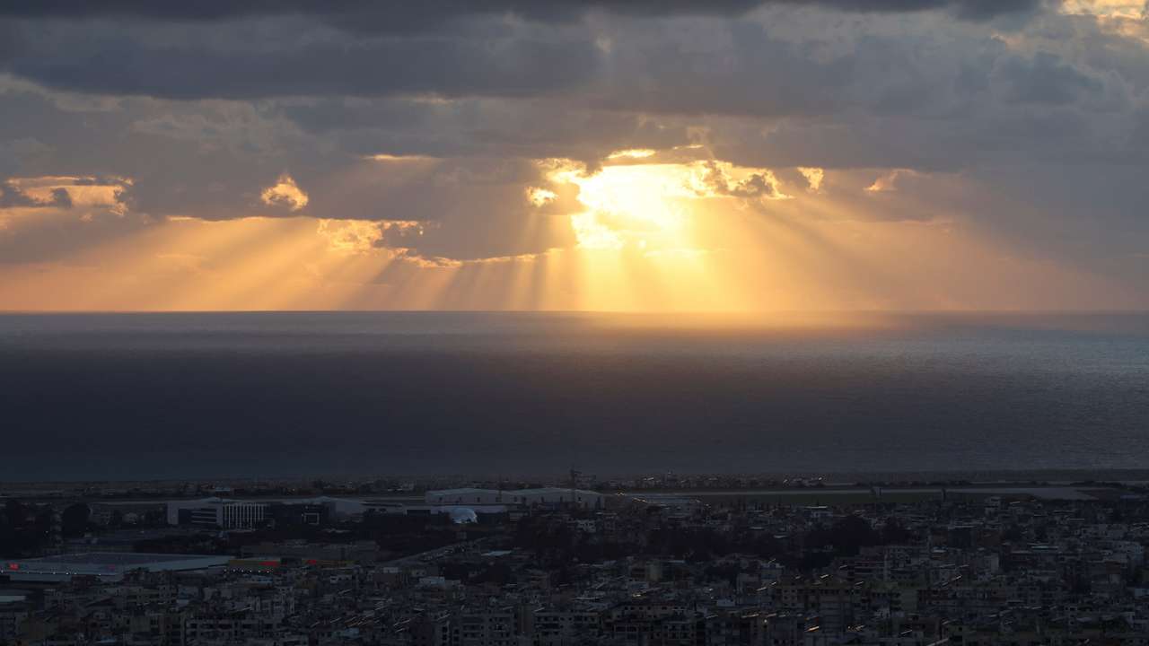 Rays of sunlight break through a cloud over Beirut's southern suburbs, amid escalating hostilities between Israel and Hezbollah