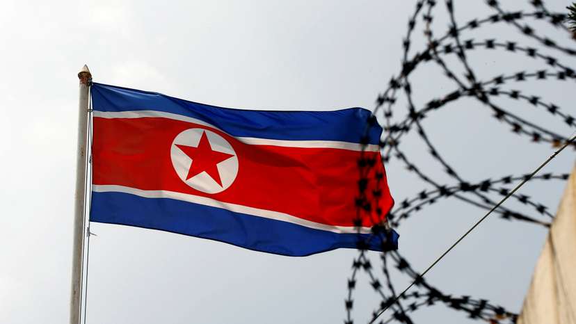 The North Korea flag flutters next to concertina wire at the North Korean embassy in Kuala Lumpur