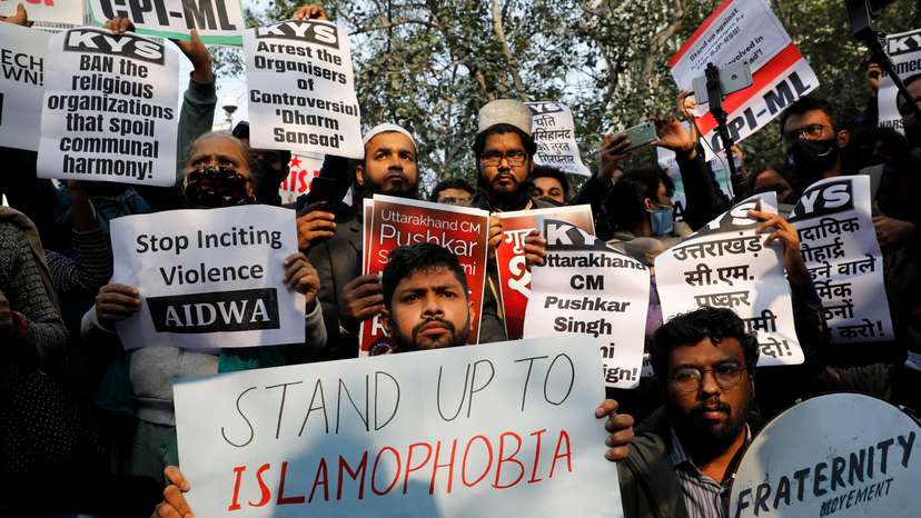 Demonstrators hold placards during a protest against what they say is hate speech against Muslims by Hindu leaders, in New Delhi