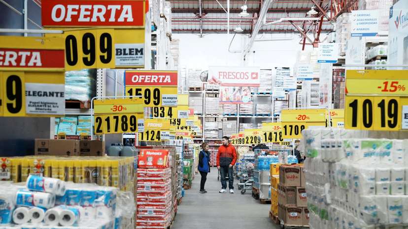FILE PHOTO: Constumers check products at a wholesaler,as Argentina is due to release consumer inflation data for April, in Buenos Aires