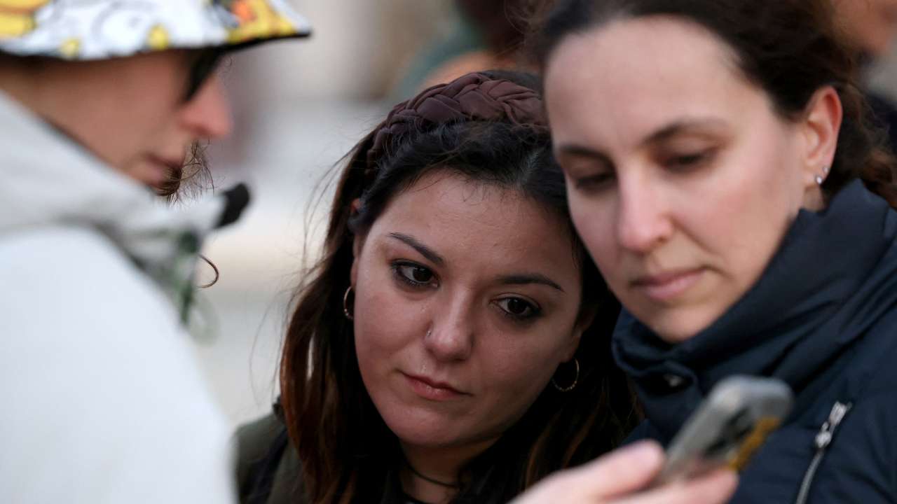 People gather outside Buckingham Palace in London
