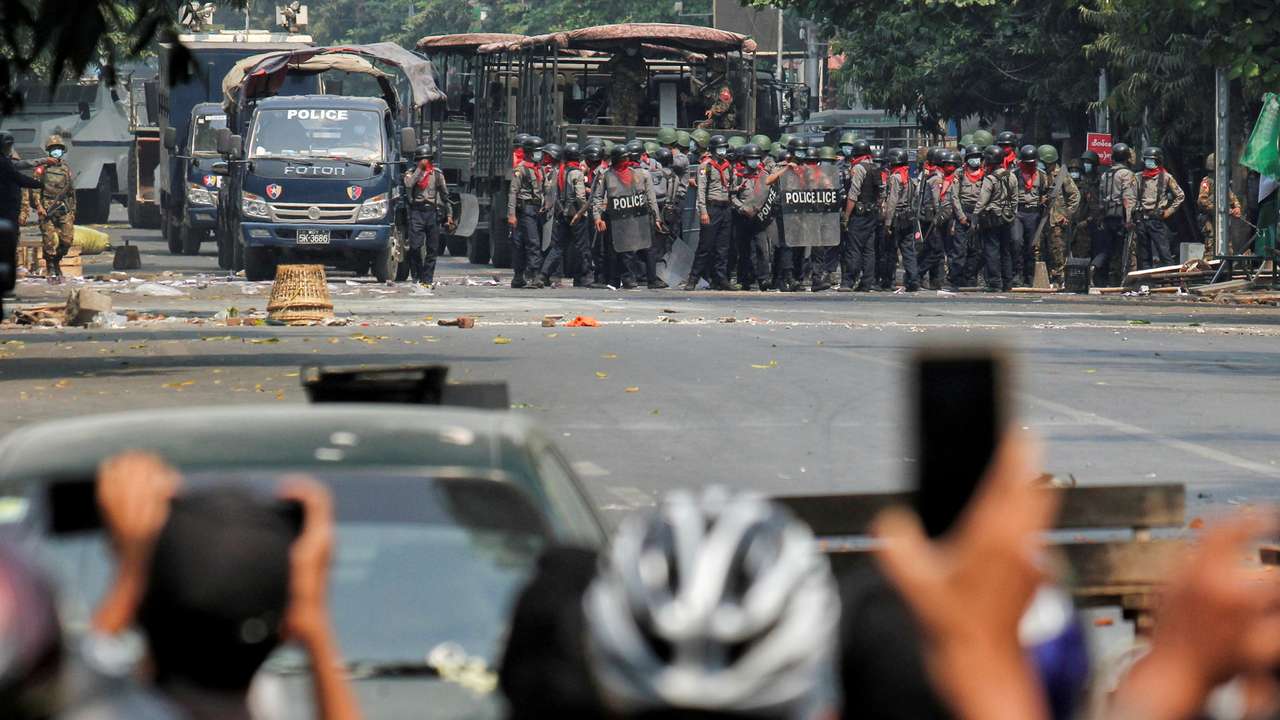 FILE PHOTO: Police stand on a road during an anti-coup protest in Mandalay