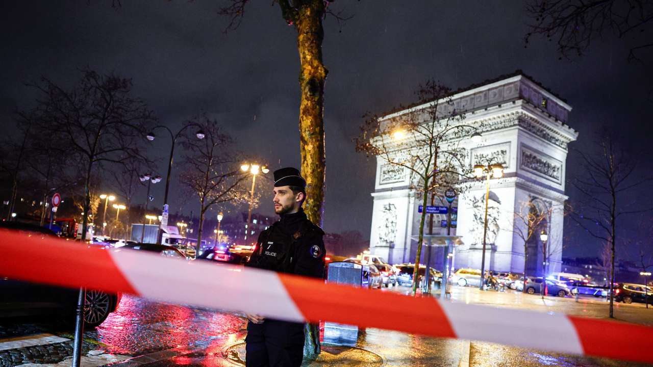 Police operate a cordon after authorities said a man armed with a knife attack a police officer near the Arc de Triomphe in Paris