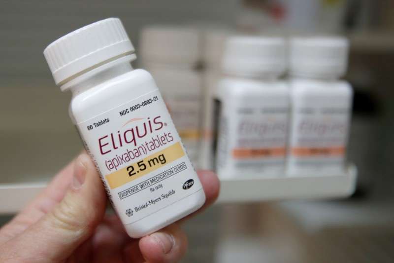 A pharmacist holds a bottle of the drug Eliquis, made by Pfizer Pharmaceuticals, at a pharmacy in Provo