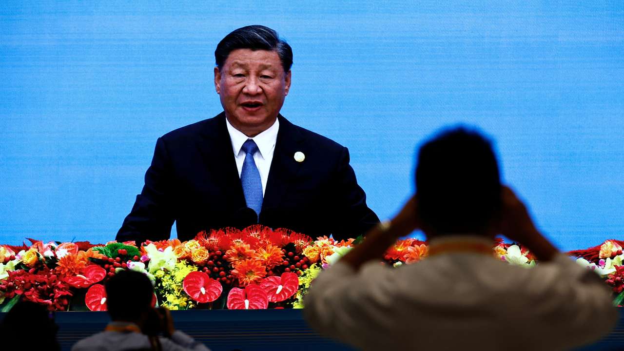 Journalists watch a giant screen broadcasting footage of Chinese President Xi Jinping at the opening ceremony of BRF in Beijing