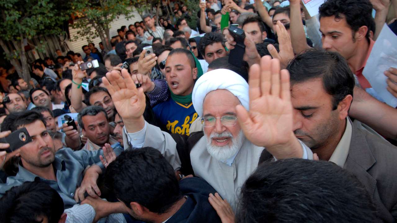 FILE PHOTO: Iran's presidential candidate Karroubi joins a crowd of supporters in Tehran